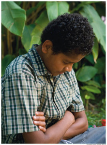 Prayer is one way to know God better. Boy praying.