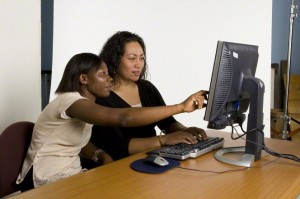 mother and daughter homeschooling on computer