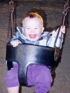 Jane's son, who has Down Syndrome, in a baby swing