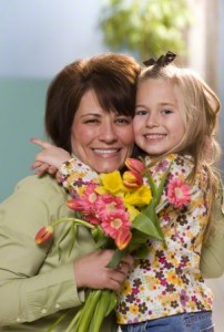 Child giving mother flowers