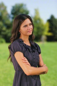 modestly dressed young woman pondering