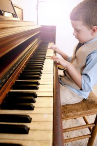 young boy playing piano