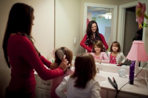 mother brushing children's hair