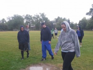 People walking around a puddle