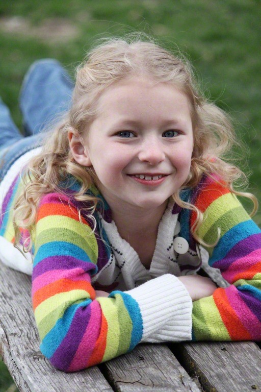 Girl smiling, relaxing outside