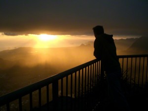 Man watching the sunset from balcony