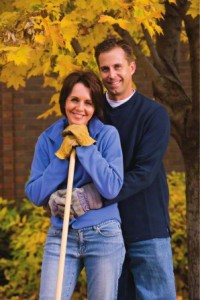 couple raking leaves