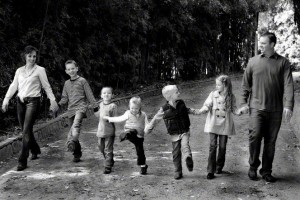 family outside holding hands