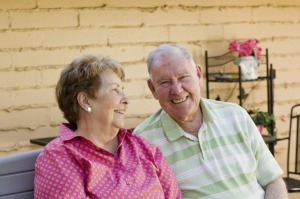 Older couple sitting together outside