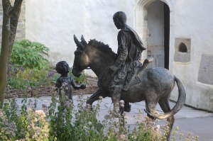 Man riding on donkey as boy watches
