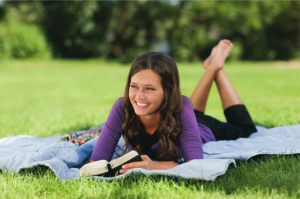 Young woman reading scriptures outside