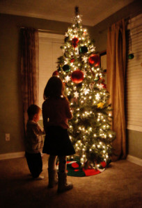 children looking at a Christmas tree