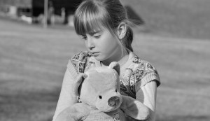 sad girl with stuffed bear