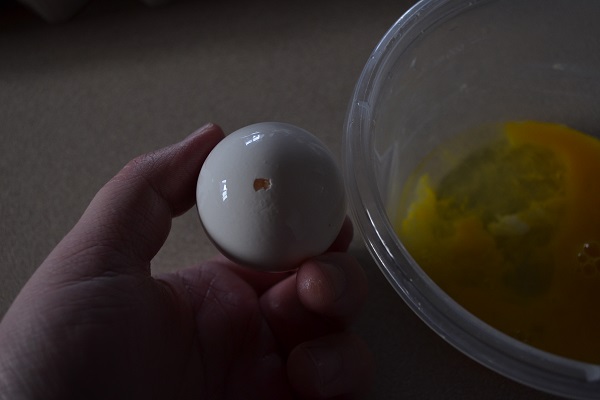 Raw egg with hole at the end