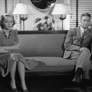 B&W shot of 1940's couple sitting apart