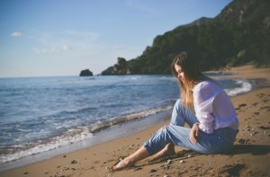 woman beach alone sad