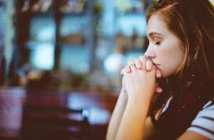 woman praying thinking