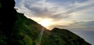 sunset bursting over a mountain