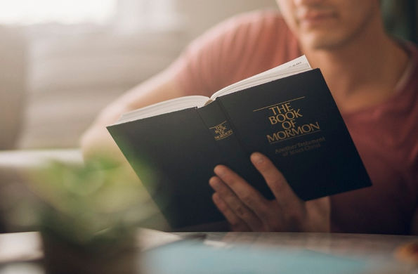 man reading book of mormon
